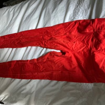 Bright orange new leggings, made by fabletics, nice thick fabric, for exercise.